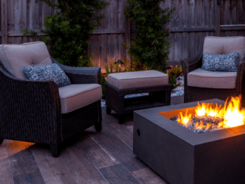 seating on a cozy patio with a fire pit burning