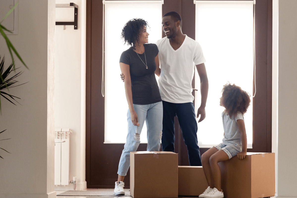millennial parents and their young child moving into their new home